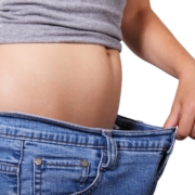woman with big jeans - health benefits of weight loss